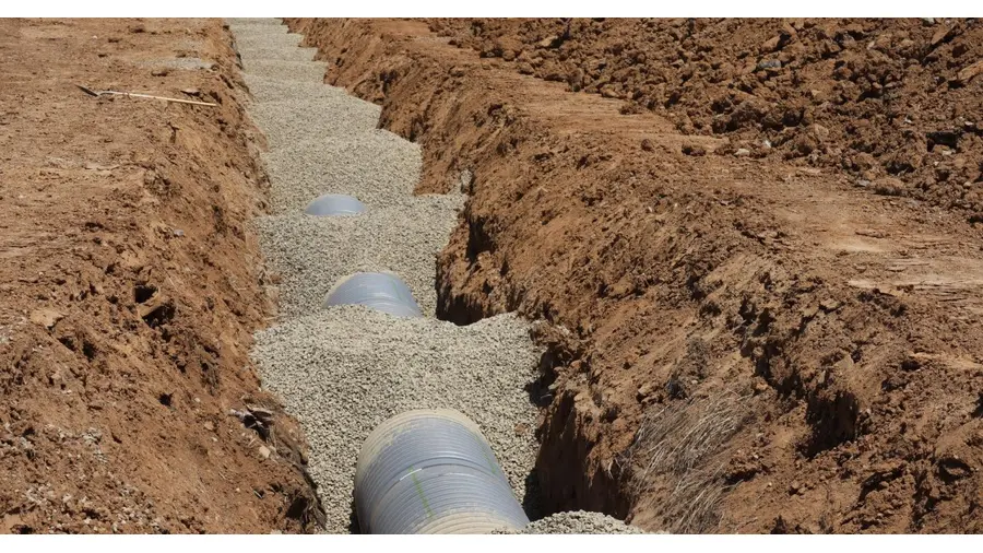 Detailed view of drainage pipe construction in a trench, Elk Grove, California.